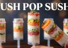 Push pop sushi con strati di riso, salmone e avocado in una presentazione moderna e colorata